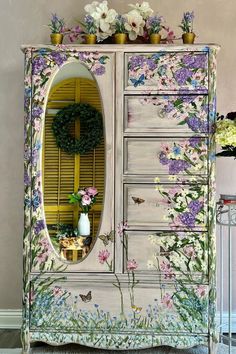 a dresser with flowers painted on it