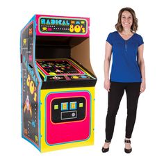 a woman standing next to an arcade machine