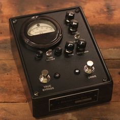 an analog device sitting on top of a wooden table