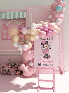 a minnie mouse birthday party with balloons and decorations