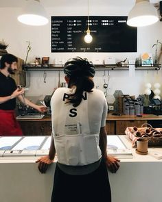 a woman standing in front of a counter