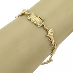 This is a beautiful bracelet, it is crafted from solid 14k yellow gold with diamond cut design on each link, the center link is Noah's arc with three animal links one each side, lion, tiger and the bear. The animals are joined together by a small oval chain link. The piece fastens with a lobster clasp.     Hallmark: Italy 14k  Material: 14k yellow gold       Measurement: 7.25" long   and 11.5mm wide x 4mm high  Weight:  9.2 grams Noah's Arc, Noahs Arc, Animal Bracelet, Gold Animals, Gold Link Bracelet, Lion Tiger, Fine Jewelry Bracelets, The Animals, The Bear