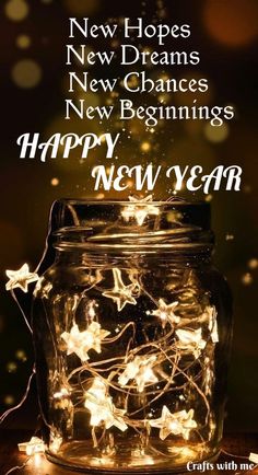 a mason jar filled with stars and lights for new year's greetings on a table