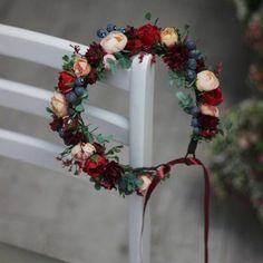 a white chair with a floral wreath on it