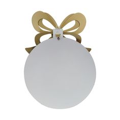 a white round ornament with gold bows on the front and back of it