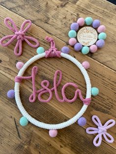 a pink and white beaded bracelet with the word blaa on it next to some beads