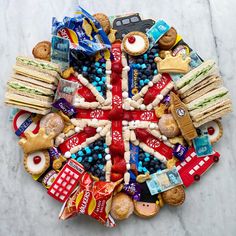 an assortment of snacks arranged in the shape of a british flag on a marble surface