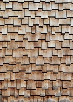 a close up view of a wooden wall made out of squares and rectangles