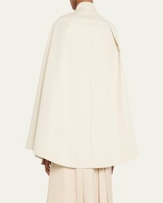 Max Mara "Valdez" cape in a flowing silhouette     Stand collar; concealed button front    Sleeveless    Front welt pockets    Oversized fit     Cotton    Made in Italy Elegant Cape Poncho For Work, Elegant Oversized Cape Poncho, Elegant Oversized Poncho Cape, Chic Capelet For Workwear, Oversized Elegant Cape For Spring, Oversized Cape With Cape Sleeves, Oversized Chic Cape, Spring Workwear Cape, Bergdorf Goodman