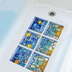 a close up of a bath tub with glass tiles on it