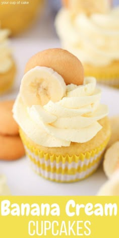 cupcakes with white frosting and banana slices on top are arranged in rows