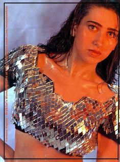 a woman in a shiny top posing for the camera