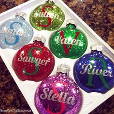 six personalized christmas ornament in a box with the names and numbers on them