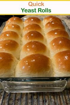 bread rolls in a glass baking dish sitting on a rack with the words quick yeast rolls