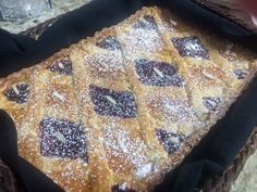 a pastry in a basket with powdered sugar on top