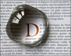 a magnifying glass with the letter d in it's center surrounded by words