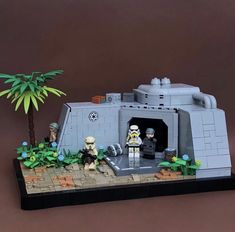 a lego star wars scene is displayed on a brown surface with palm trees and people