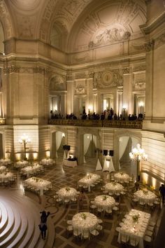 a large room with tables and chairs set up for a formal function in the center