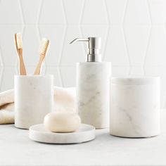 marble bathroom accessories including soap dispenser and toothbrush holder