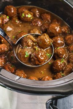 a ladle scooping some meatballs out of the slow cooker