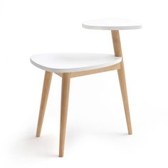 a white chair with wooden legs and a round table on the back side, in front of a white background