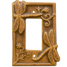 a decorative light switch plate with dragonflies on the front and back cover in gold