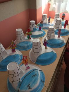 children's paper plates with cartoon figures on them sitting on a table in front of a window