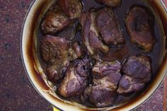 a pot filled with meat sitting on top of a table