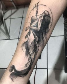 a tattoo on the arm of a woman with a hat and long hair is shown