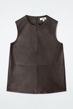 The womenswear designers offer a refined take on the sleeveless top for Autumn Winter 2024. Crafted from supple leather, this paneled piece is tanned a rich espresso tone and stitched with bust darts to define the shape. It features an exposed zip at the back and side slits at the hem. Regular fitZip closureCOS supports responsible manufacturing via the Leather Working Group Shell: 100% Leather. Excluding trims / Specialist clean Back length of size 6 is 24.72" / Model wears a size 6 Leather Tank Top, Autumn Winter 2024, Male Magazine, Outerwear Vest, Vest Shirt, Winter 2024, Trouser Jeans, Outerwear Women, Leather Top