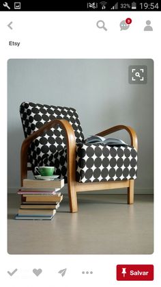 a black and white chair sitting next to a stack of books