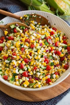 a large bowl filled with corn and vegetables