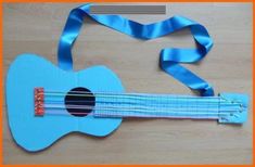 a blue guitar made out of paper and ribbon