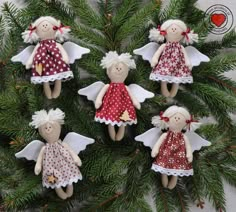 six little angel ornaments hanging from a christmas tree