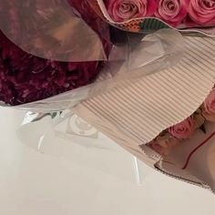 a bouquet of pink roses wrapped in cellophane