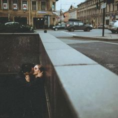 a man and woman kissing on the street