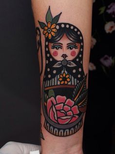 a woman's arm with a tattoo on it and a flower in her hair