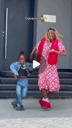 two young men are dancing in front of a building with stairs and steps behind them