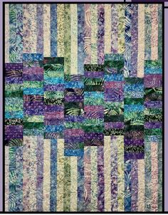 a quilt made with many different colors and patterns on the front, side, and back