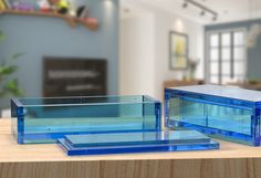 three glass containers sitting on top of a wooden table