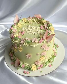 a green cake with pink and yellow flowers on it