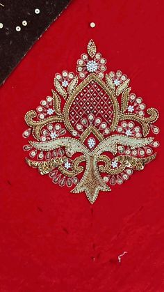 an embroidered red cloth with gold and white designs on the front, along with other fabric material