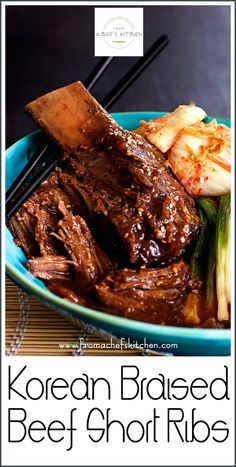 korean braised beef short ribs on a blue plate with chopsticks in it