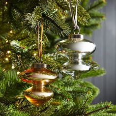 three ornaments hanging from a christmas tree