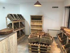 a room filled with lots of wooden crates and baskets