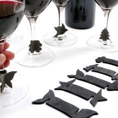 several wine glasses with different shapes and sizes are being held by someone's hand