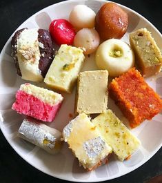 a white plate topped with lots of different types of desserts on top of it