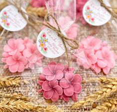 pink flowers are tied to twine and placed on burlock with tags attached