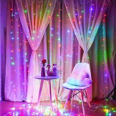 a chair and table in front of a curtained window with lights all around it