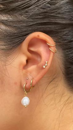 a close up of a person with ear piercings